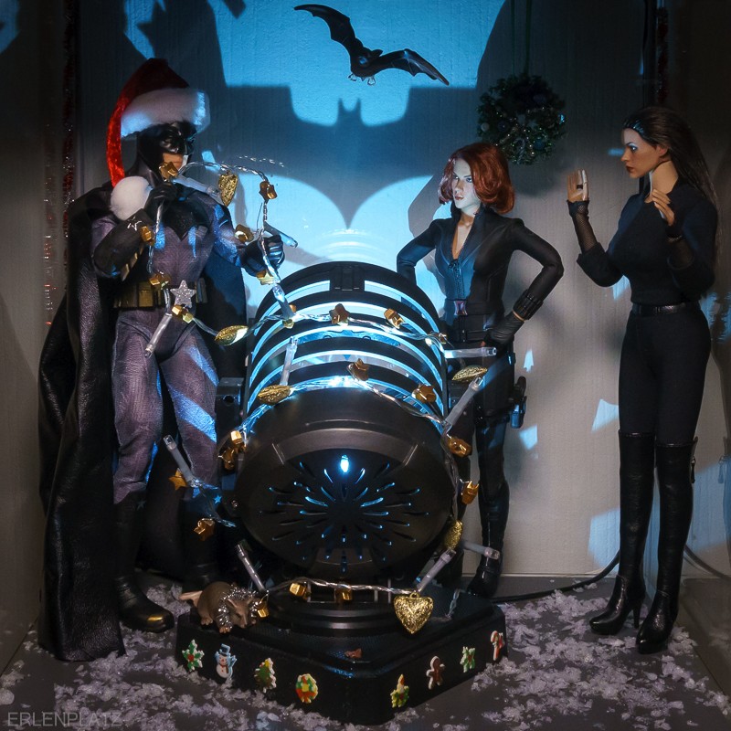 Batman (Mattel) , Black widow (Hot Toys), Catwoman (Hot Toys) stehen um das Batsignal herum.